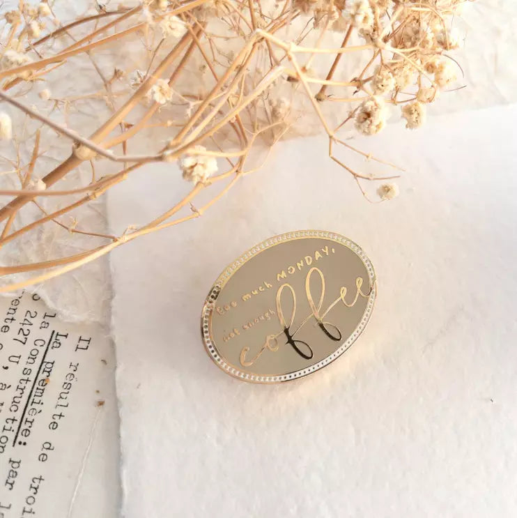 Round Coffee Journal Clip with cursive text styled with dried flowers on a textured surface