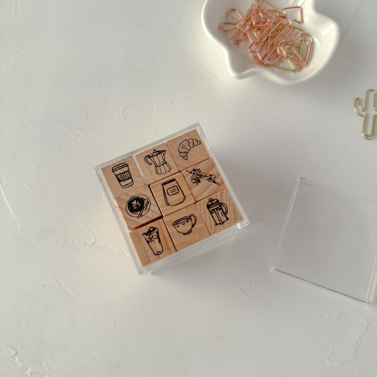 Set of rubber stamps with coffee-themed designs on a white surface.