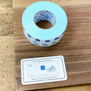 Roll of Coffee Time Label Sticker Tape in blue with its label displayed on a wooden surface