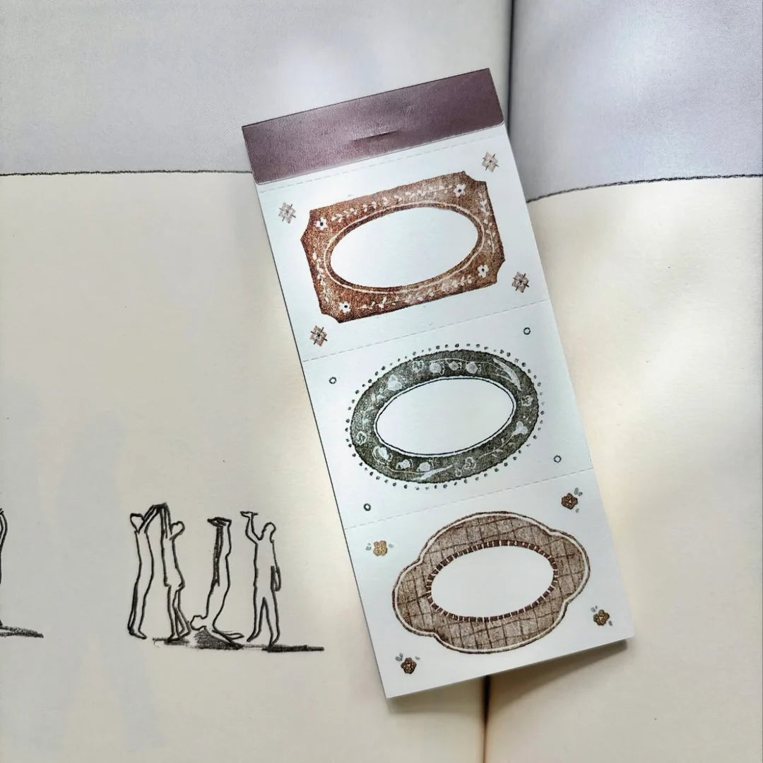 Confectionery Series 3-Frame Memo Pad packaging with oval frame designs on a white surface
