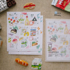 Sticker sheets with food-themed designs on a textured surface