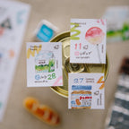 Collection of small food packages with labels on a blurred background