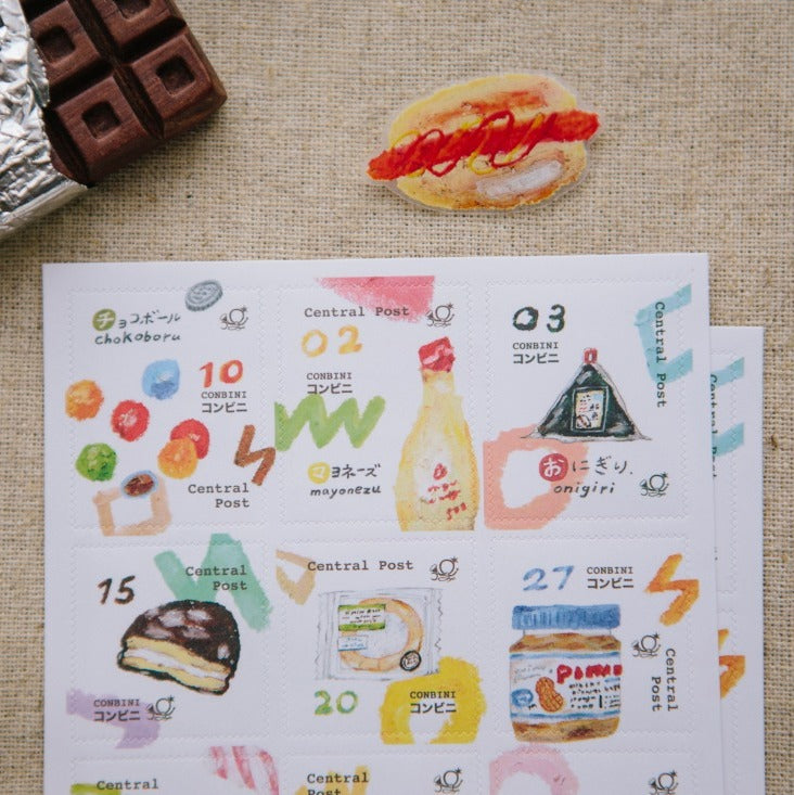 Collection of illustrated food items on a paper sheet with a hot dog and chocolate bar on a textured surface.