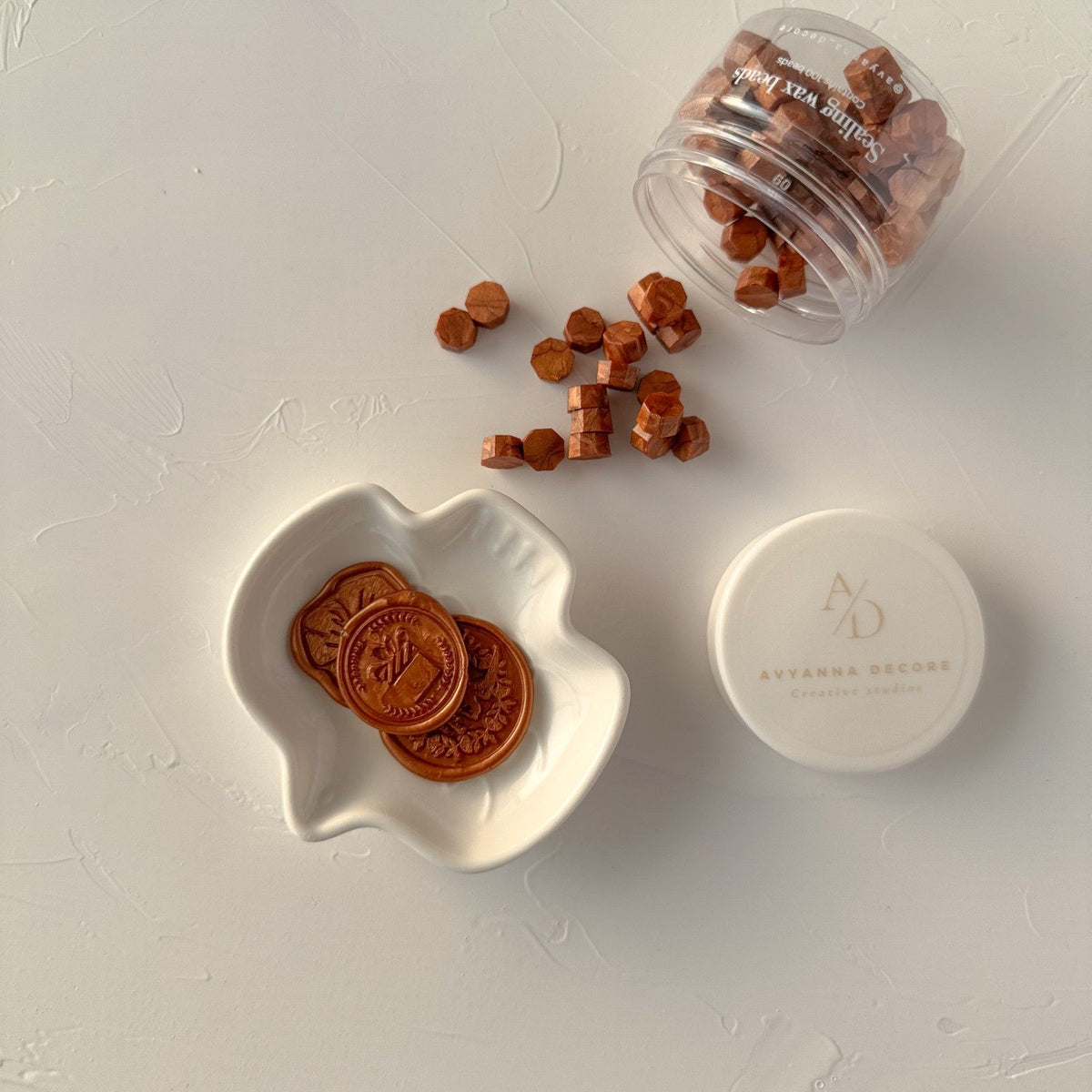 Small container of Copper Wax Beads in a rich metallic brown with a white lid on a light grey surface