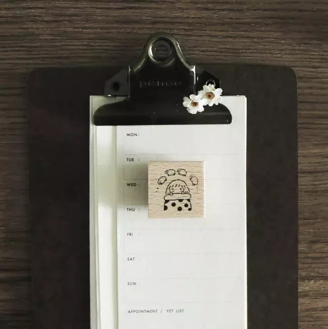 Mini Girls Counting Sheep stamp with a clipboard calendar styled on a warm wooden surface