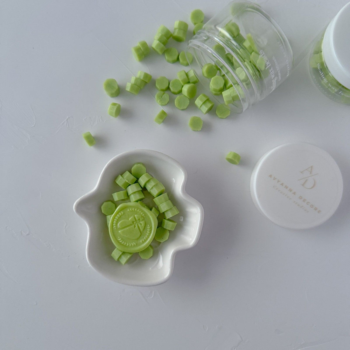 Cucumber Cooler Wax Beads in a fresh minty green shade piled in a small white dish on a grey background