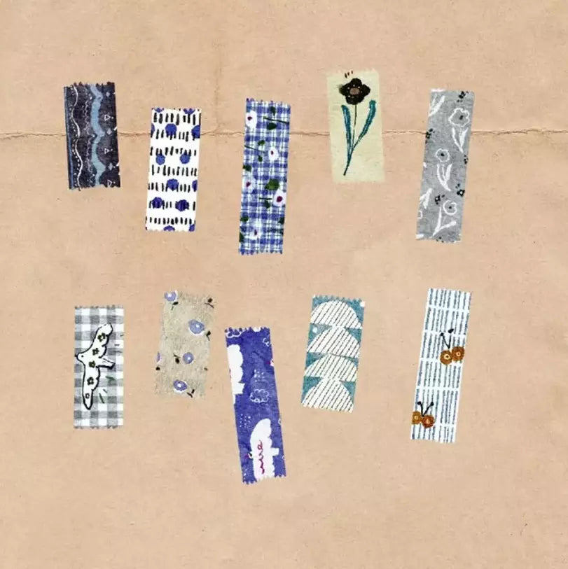 Collection of patterned washi tape strips on a cardboard background