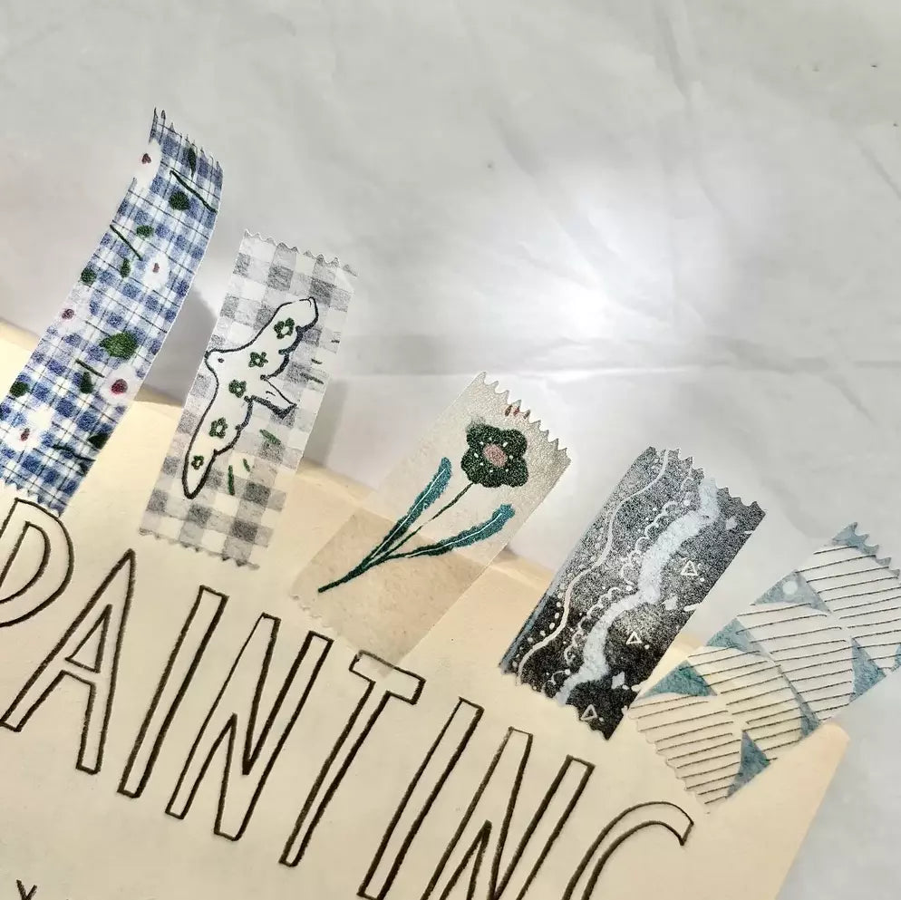 Cut-Out Washi Tape textile-style pattern samples arranged on a textured surface, detail view