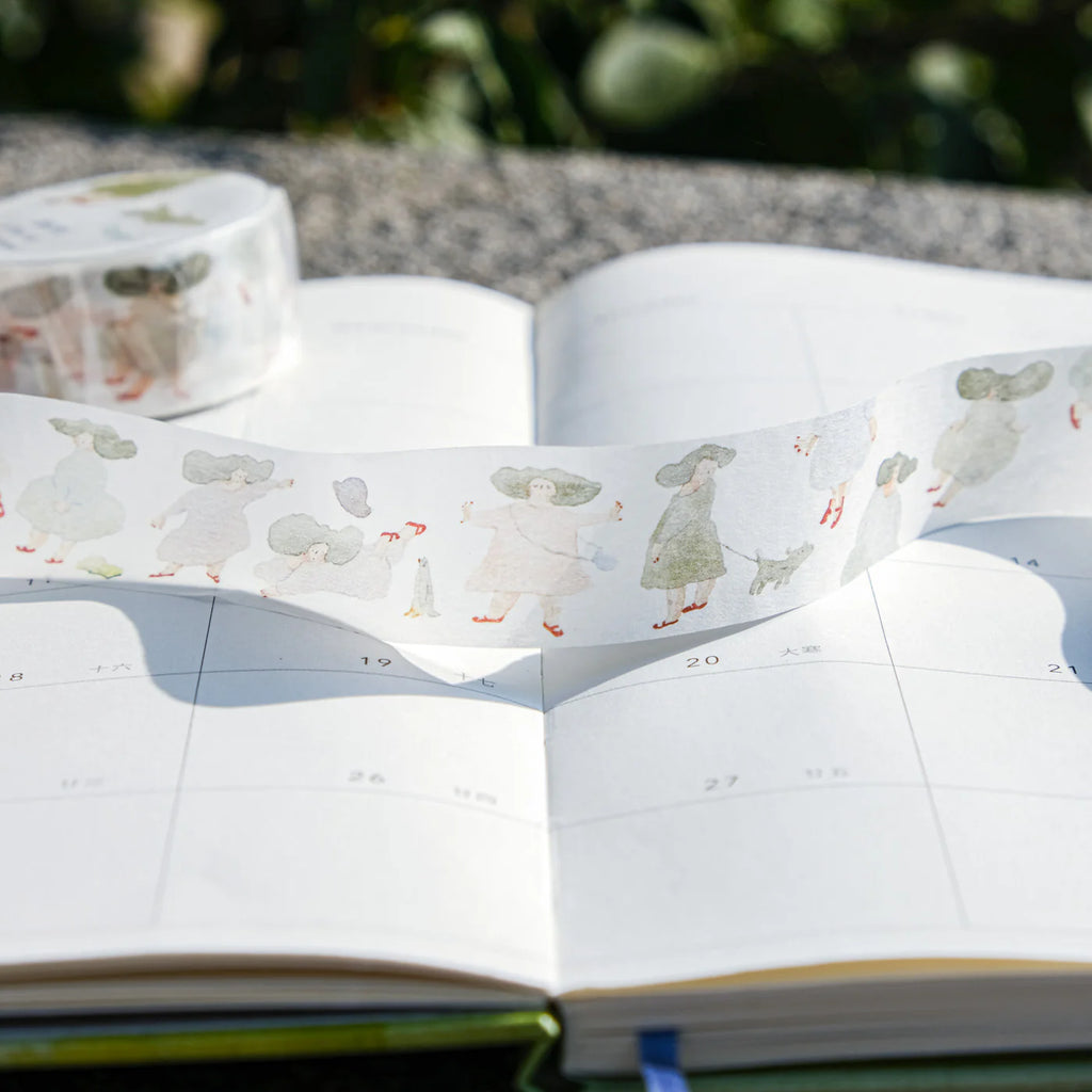 A Pair of Red Shoes Washi Tape by Dodolulu — people-and-dogs washi tape in an open book, for journaling