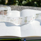 A Pair of Red Shoes Washi Tape by Dodolulu — people-and-dogs washi tape in an open book, for journaling