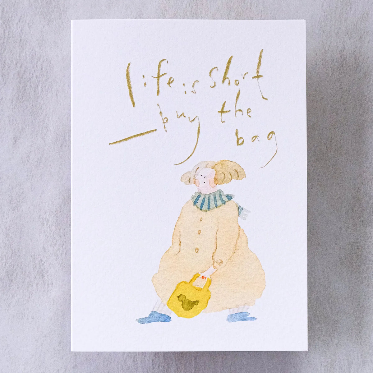 Buy The Bag Greeting Card by Dodolulu — figure with a bag, 'life is short, buy the bag' quote, for gifting