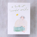 Wonder Awaits Greeting Card by Dodolulu — figure and 'a world of wonder awaits' text on grey, for gifting