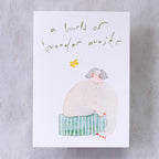Wonder Awaits Greeting Card by Dodolulu — figure and 'a world of wonder awaits' text on grey, for gifting