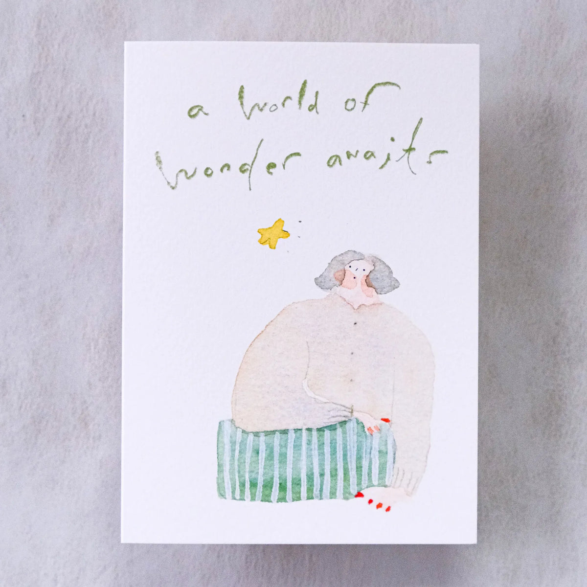 Wonder Awaits Greeting Card by Dodolulu — figure and 'a world of wonder awaits' text on grey, for gifting