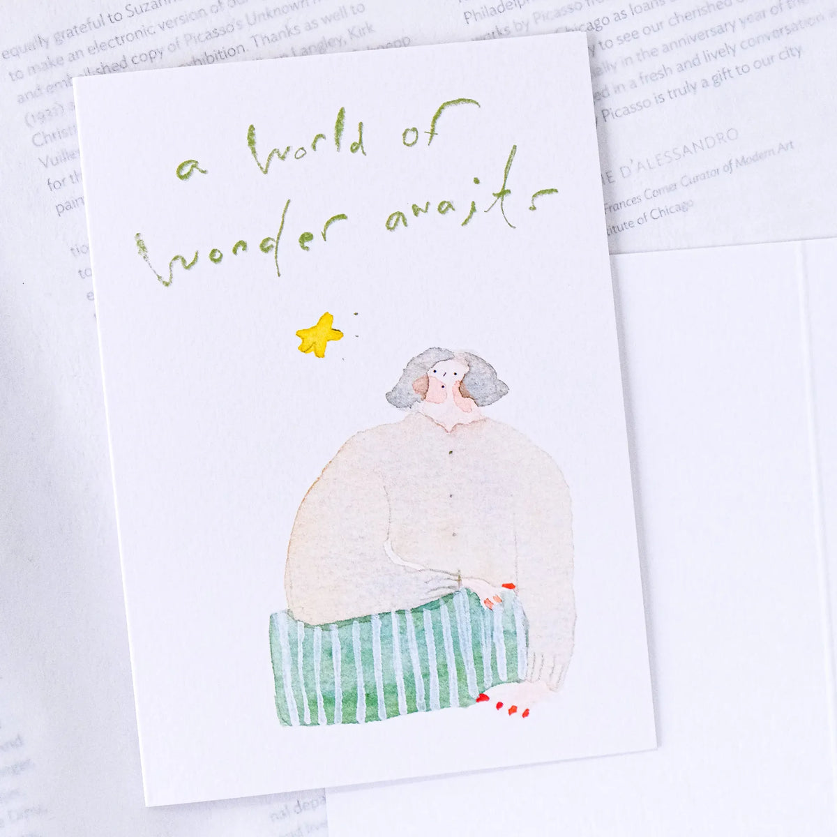 Wonder Awaits Greeting Card by Dodolulu — figure holding a star, wonder-awaits card on white, for gifting