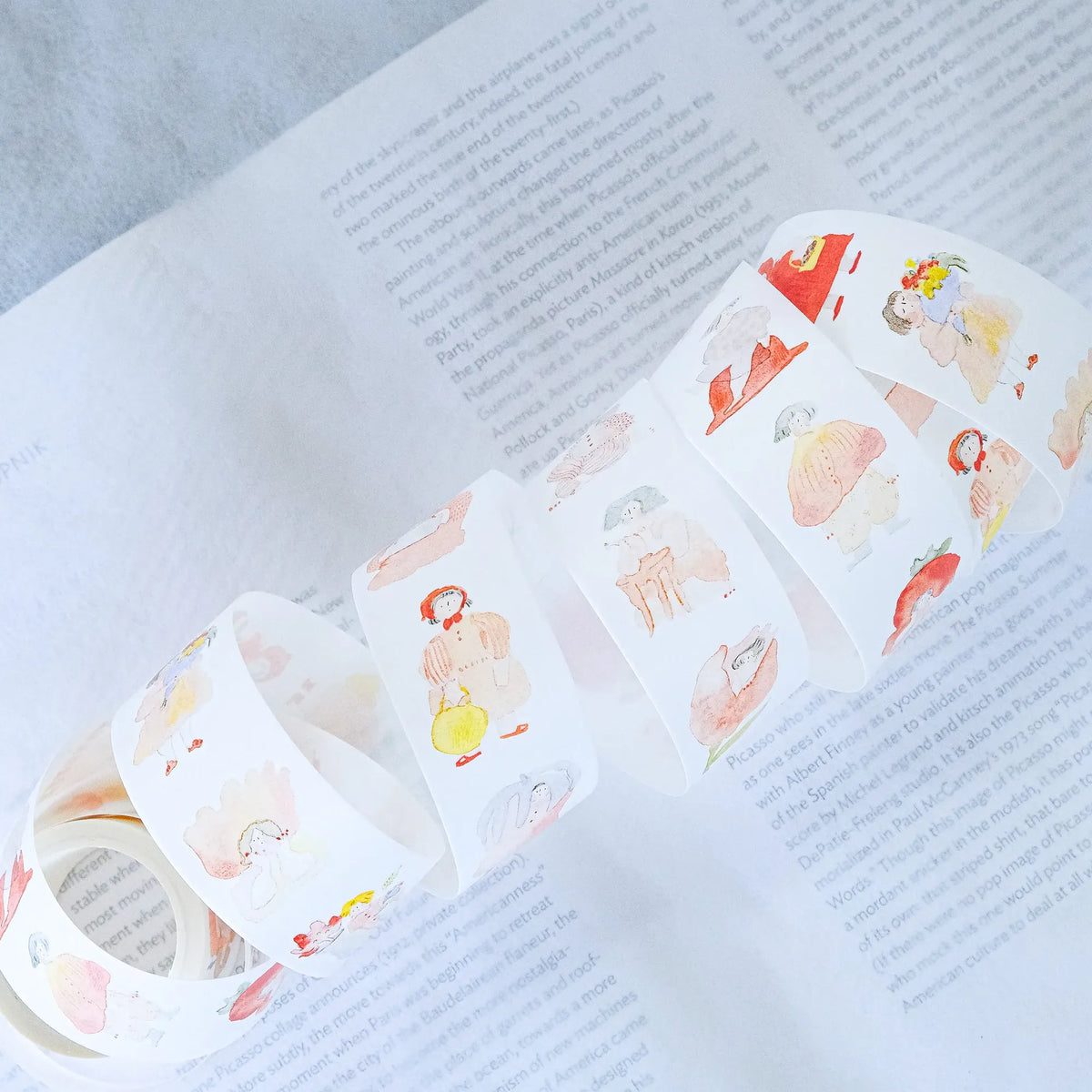 Seasons Quartet Vol.1 Washi Tape by Dodolulu — character washi tape roll on an open book, for journaling