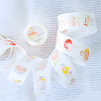 Seasons Quartet Vol.1 Washi Tape by Dodolulu — cartoon-character washi tape on a book page, for journaling