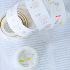 Seasons Quartet Vol.3 Washi Tape by Dodolulu — animal-illustration washi tape roll on a book page, for journaling