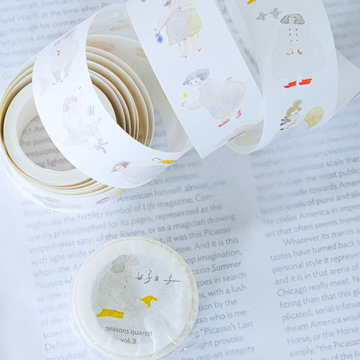 Seasons Quartet Vol.3 Washi Tape by Dodolulu — animal-illustration washi tape roll on a book page, for journaling