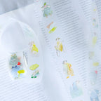 Seasons Quartet Vol.4 PET Tape by Dodolulu — cartoon-character PET tape design on a book page, for journaling