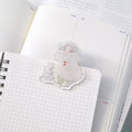 Telescope Journaling Clip by Dodolulu — clear acrylic sleepy-character clip on grid notebooks, for journaling