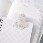 Telescope Journaling Clip by Dodolulu — clear acrylic sleepy-character clip on grid notebooks, for journaling