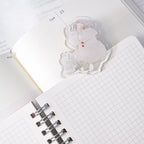 Telescope Journaling Clip by Dodolulu — acrylic Santa-illustration clip on grid notebooks, for journaling