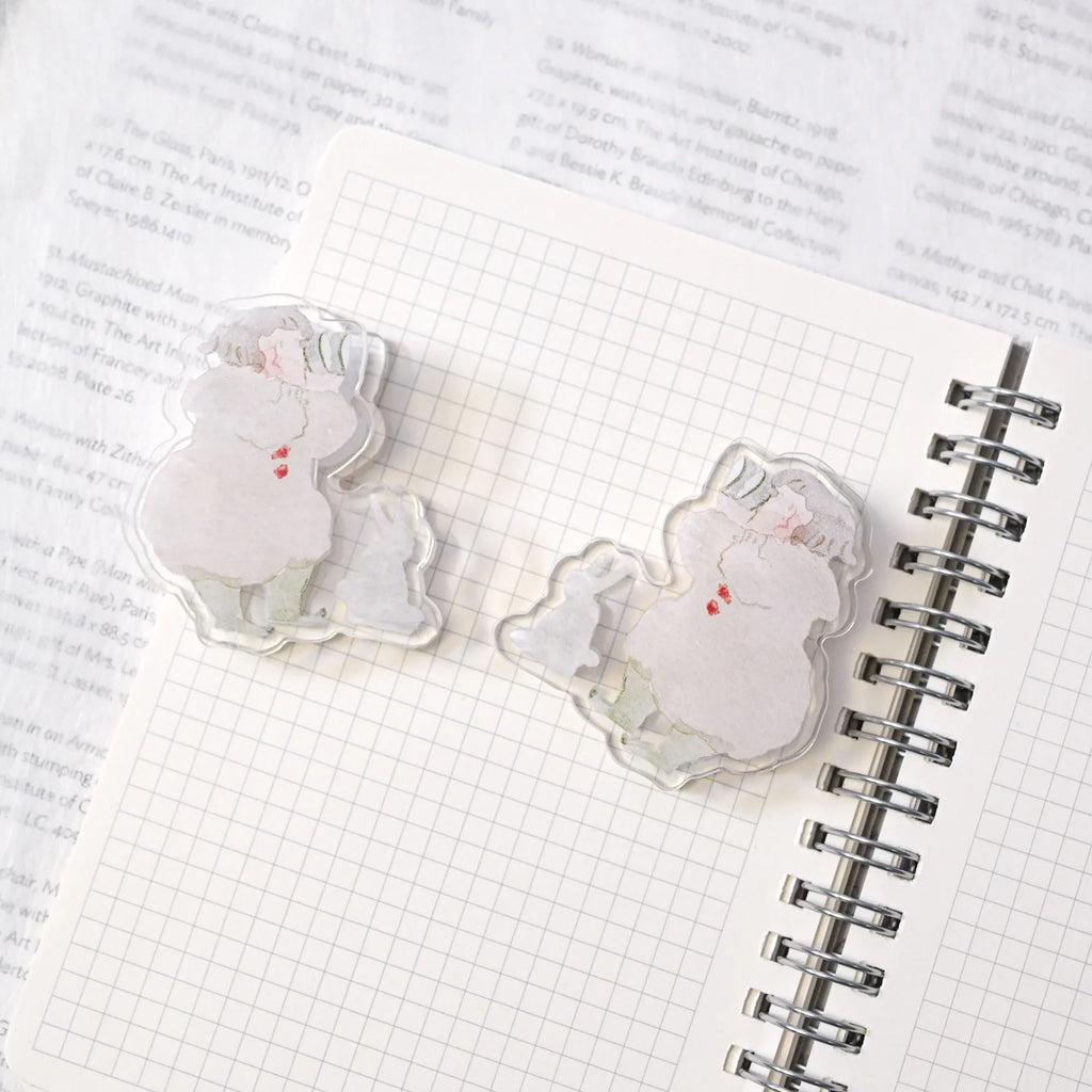 Telescope Journaling Clip by Dodolulu — two acrylic winter-scene clips on a grid notebook, for journaling