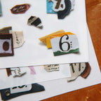 Collage of torn pieces of paper with various text and images on a white background.