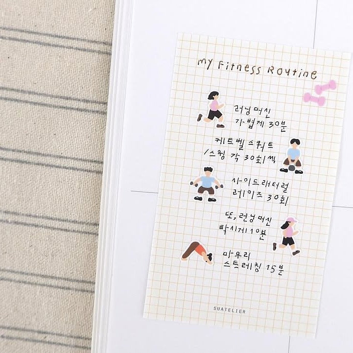 Notebook with a fitness routine illustration on a textured surface, from the Deco 15 Sticker Sheet