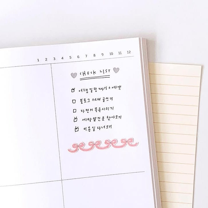 Checklist in a planner with a pink signature at the bottom, from the Deco 13 Sticker Sheet