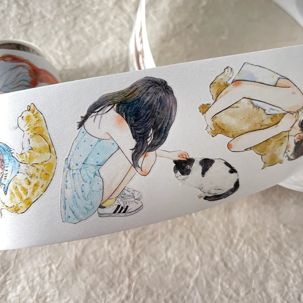 Strip of My Pet Baby 32 PET Tape girl and cat illustrations laid on a textured surface