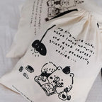 Tote bag with black illustrations and text on a white background