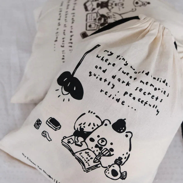 Black One Stamp at a Time Drawstring Pouch with black illustrations and text on a white backdrop
