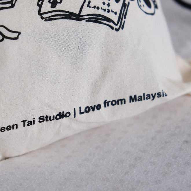 Close-up of the One Stamp at a Time pouch fabric with black text and stamp graphics on grey