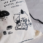 White pillow with black illustrations and text on a light gray background