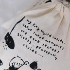 Canvas bag with black text and illustrations on a white background