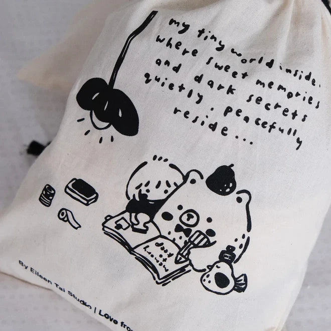 White One Stamp at a Time pouch with black illustrations and text on a light grey backdrop