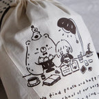 Beige drawstring bag with black illustrations and text on a white background