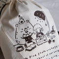 Beige drawstring bag with black illustrations and text on a white background