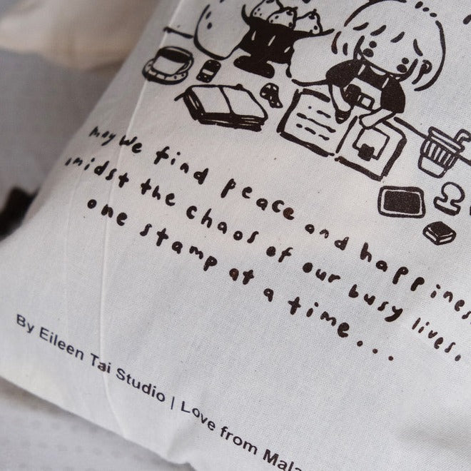 One Stamp at a Time pouch artwork of a child at a desk with a quote on a white background