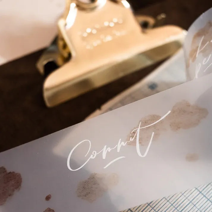 Close-up of Dream Time Calligraphy PET Tape lettering detail applied to packaging on a white surface