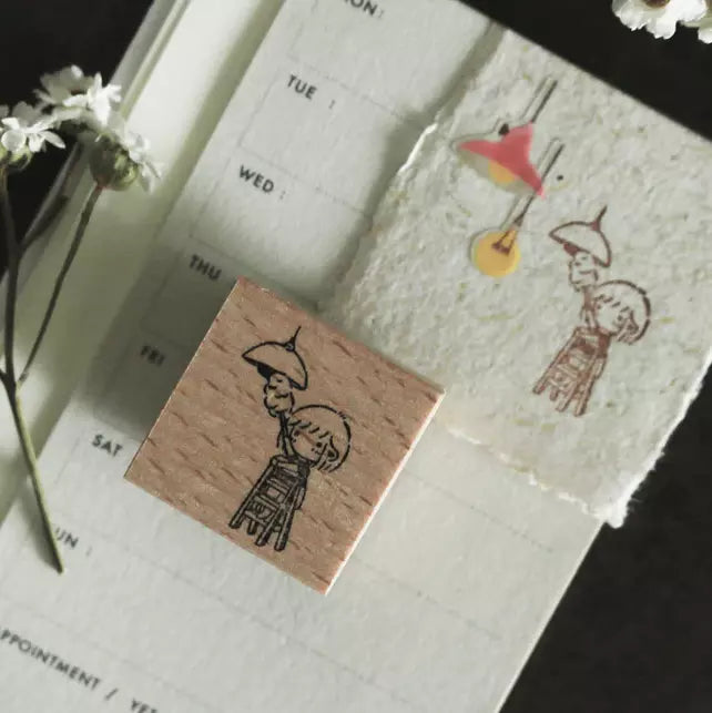 Mini Girls Dusting stamp with a girl and bird design displayed on a printed paper sheet