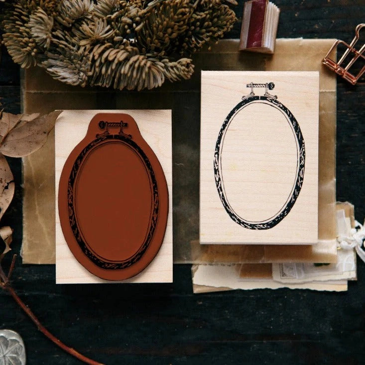 Ellipse Embroidery Hoop Rubber Stamp impressions styled as two frames on a dark surface
