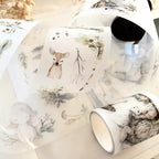 Set of ceramic cups with nature-themed designs on a light background