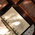 Open notebook with text on a wooden surface