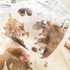 Decorative paper with brown leaf patterns and a pink flower on a white background