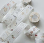 Decorative washi tape rolls with various designs on a light background
