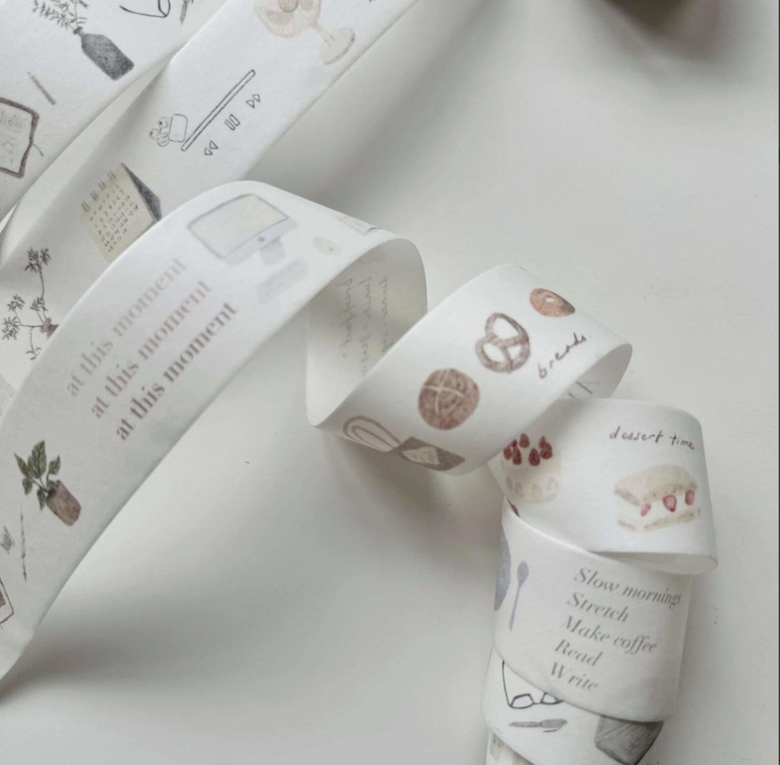 Rolls of decorative tape with various designs on a light background