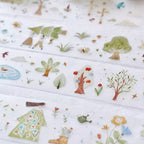 Children's fabric with nature-themed illustrations including trees, flowers, and animals.